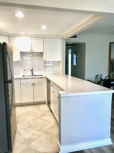 517 Fanshaw M Boca Raton, FL 33434 - Photo 6 of 11 a kitchen with a sink a refrigerator and cabinets