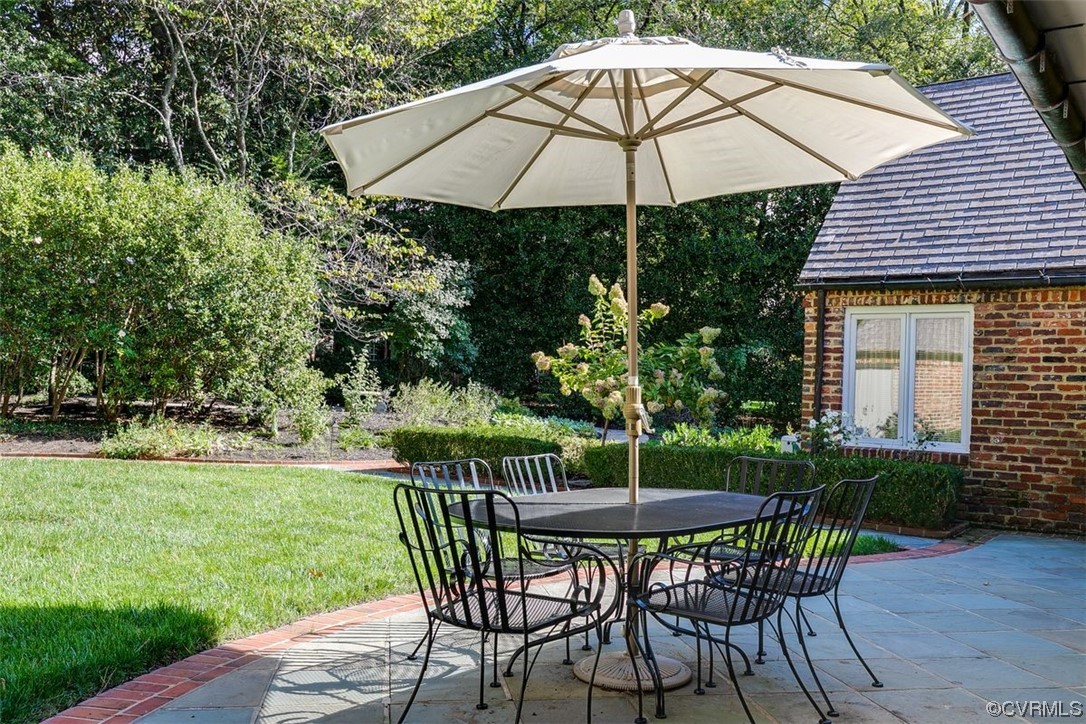 4600 Sulgrave Road Midlothian, VA 23114 - Photo 11 of 26 a patio table and chairs with an umbrella