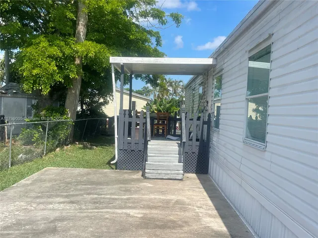 a porch with seating space and garden view