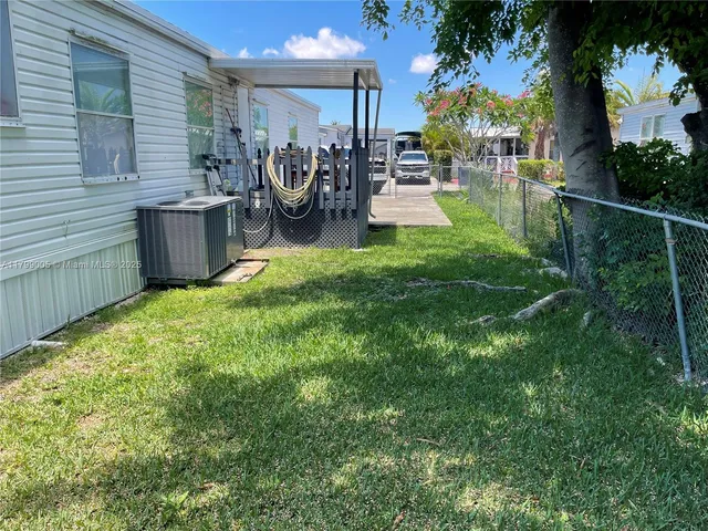 a view of a backyard with plants and a patio