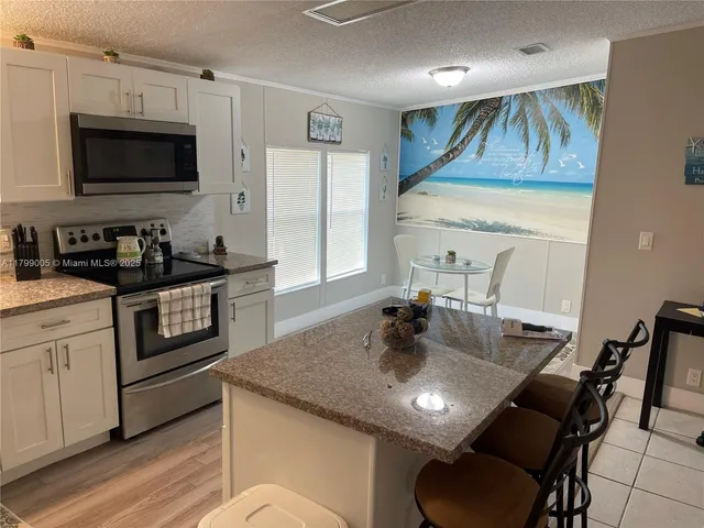 a kitchen with a stove a sink and a refrigerator