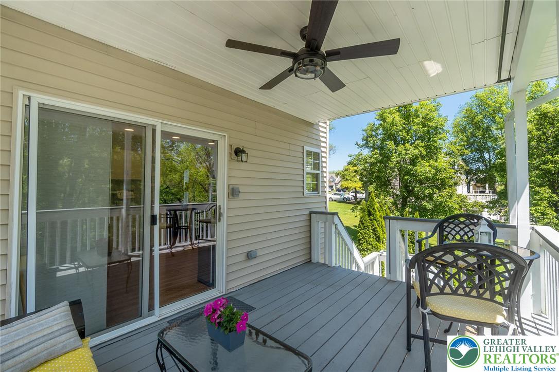 2314 Red Maple Drive Coplay, PA 18037 - Photo 60 of 73 Relax al fresco on the covered balcony, featuring a ceiling fan and outdoor dining space.