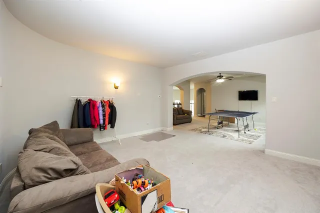 a bedroom with a bed table and a window