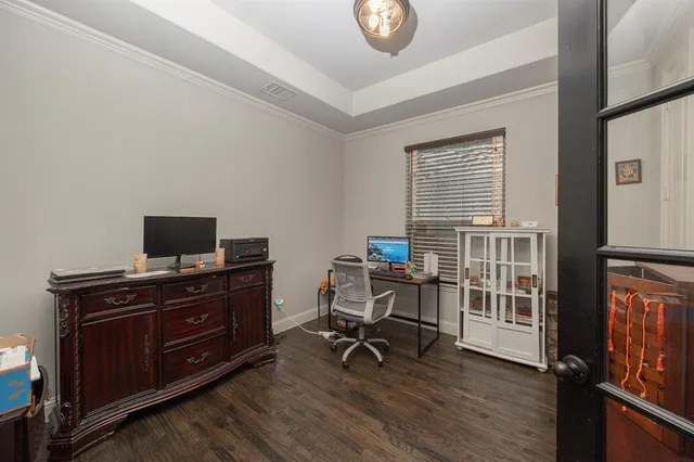 a view of a hallway with wooden floor and entryway