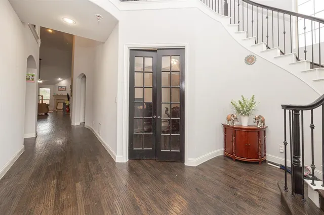 a view of entryway and hall with wooden floor