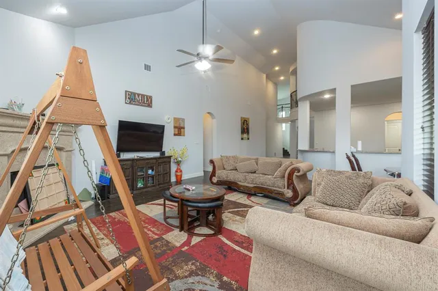 a living room with furniture a flat screen tv and a fireplace
