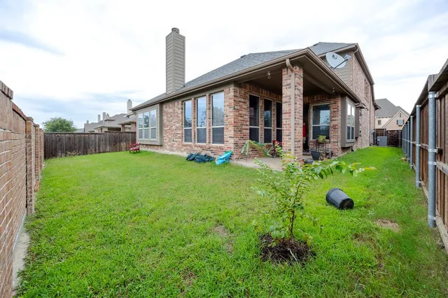 a view of a house with a yard and sitting area