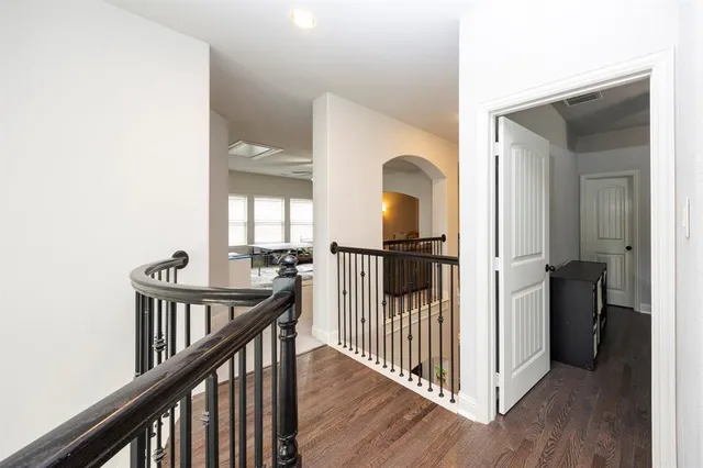 a view of staircase with railing and a window