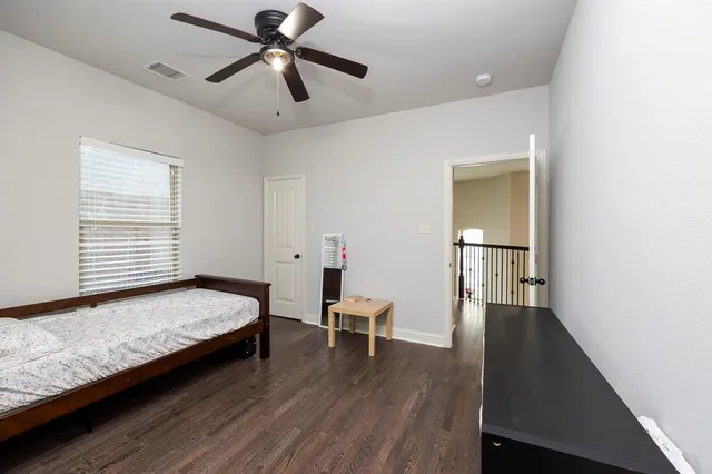 a bedroom with a bed and a chair