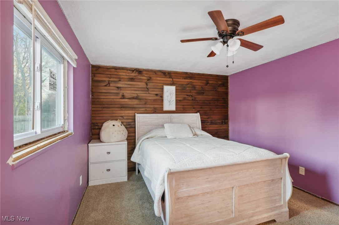 167 Birch Road Painesville, OH 44077 - Photo 22 of 49 Bedroom featuring wood walls, light carpet, and ceiling fan