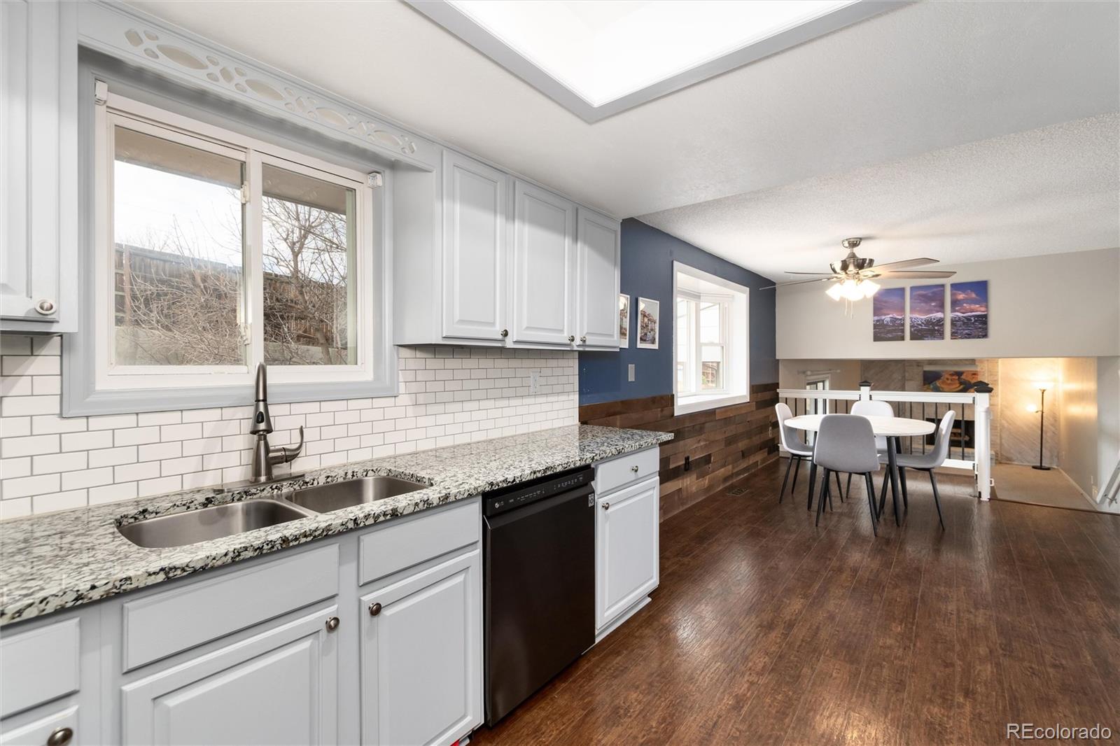 4935 South Routt Street Littleton, CO 80127 - Photo 1 of 45 a kitchen with granite countertop a sink and counter space