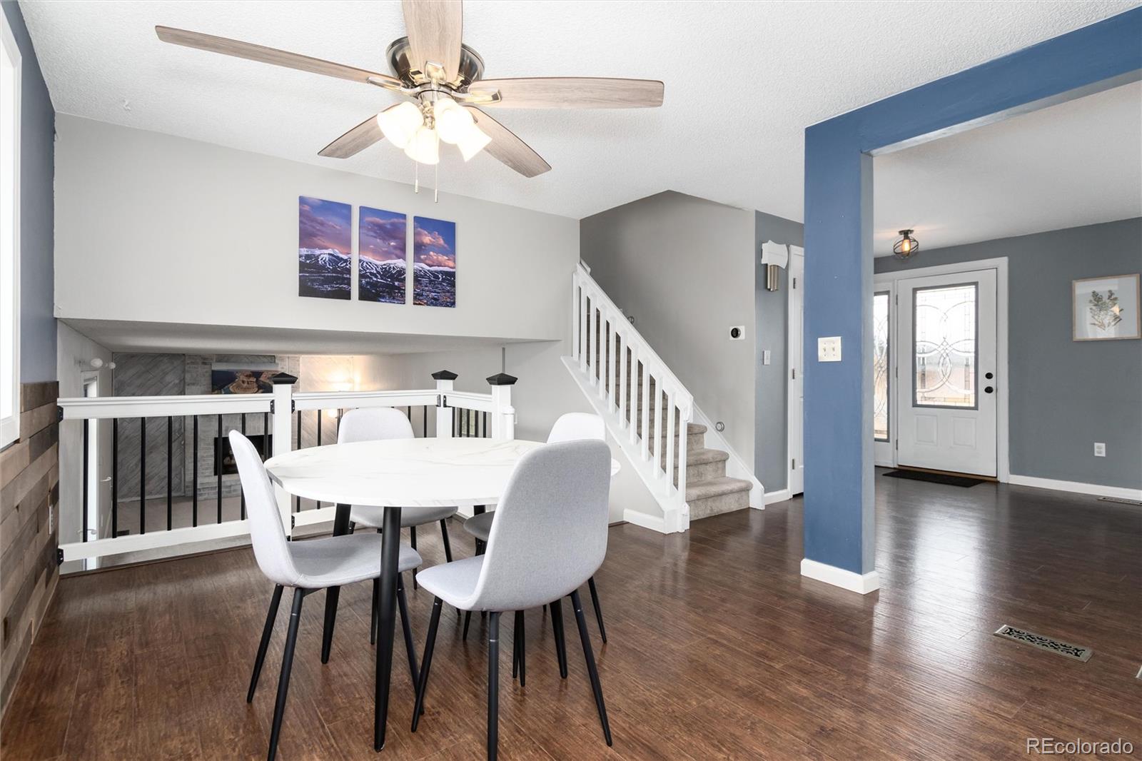 4935 South Routt Street Littleton, CO 80127 - Photo 12 of 45 a view of a dining room with furniture and wooden floor