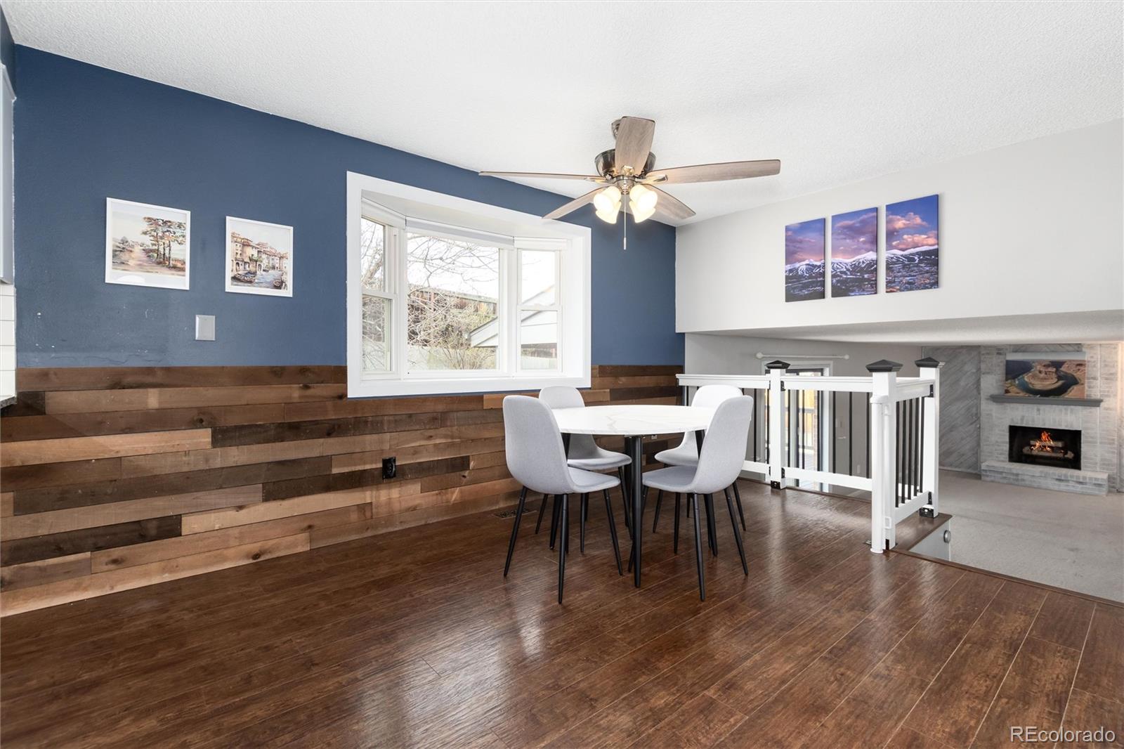 4935 South Routt Street Littleton, CO 80127 - Photo 13 of 45 a view of a dining room with furniture window and wooden floor