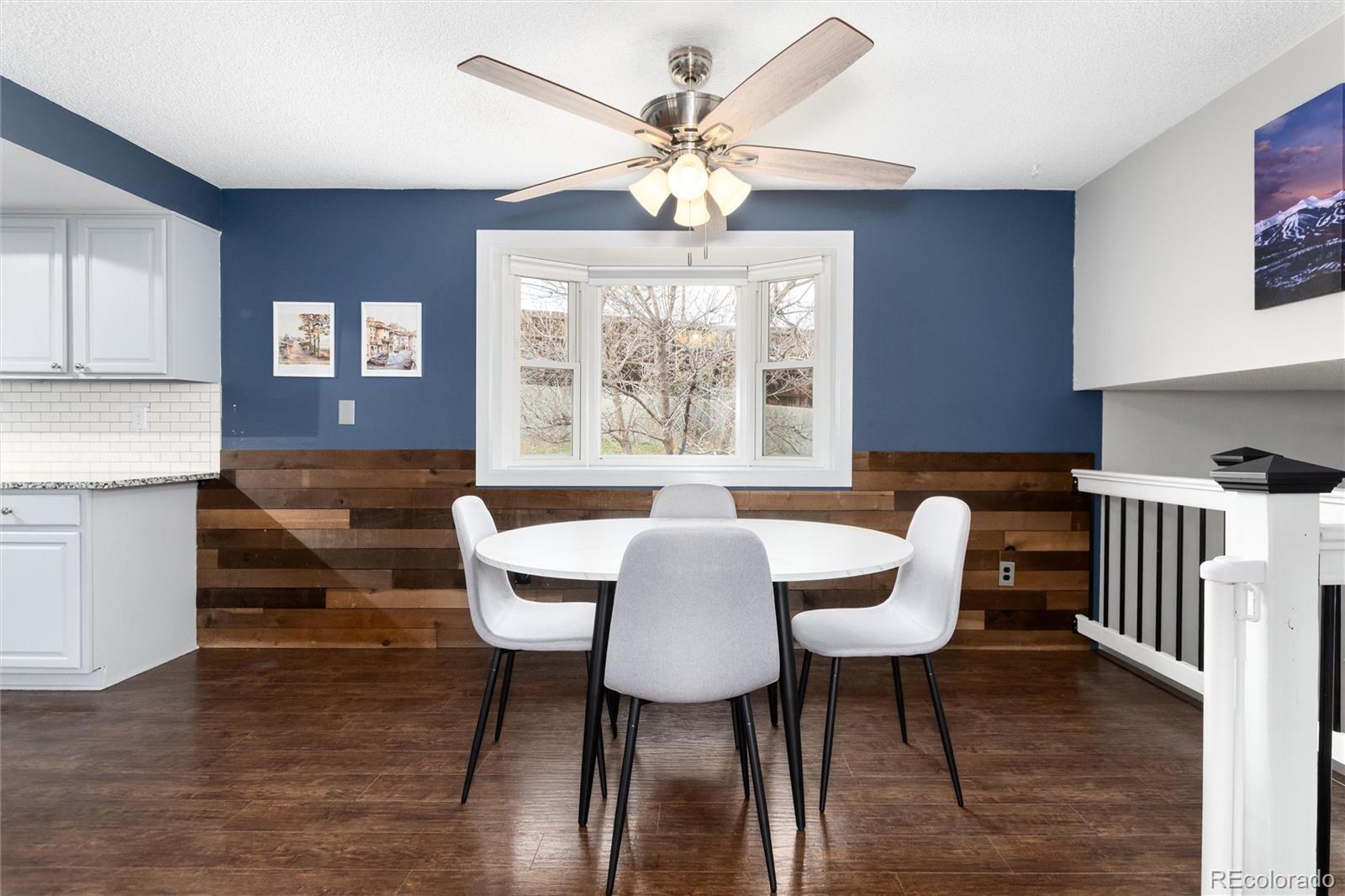 4935 South Routt Street Littleton, CO 80127 - Photo 14 of 45 a view of a a dining room with furniture window and wooden floor