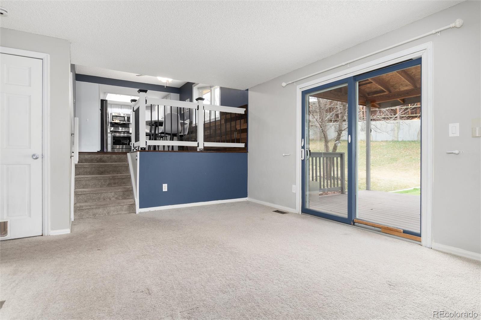4935 South Routt Street Littleton, CO 80127 - Photo 15 of 45 a view of a big room with windows and cabinet