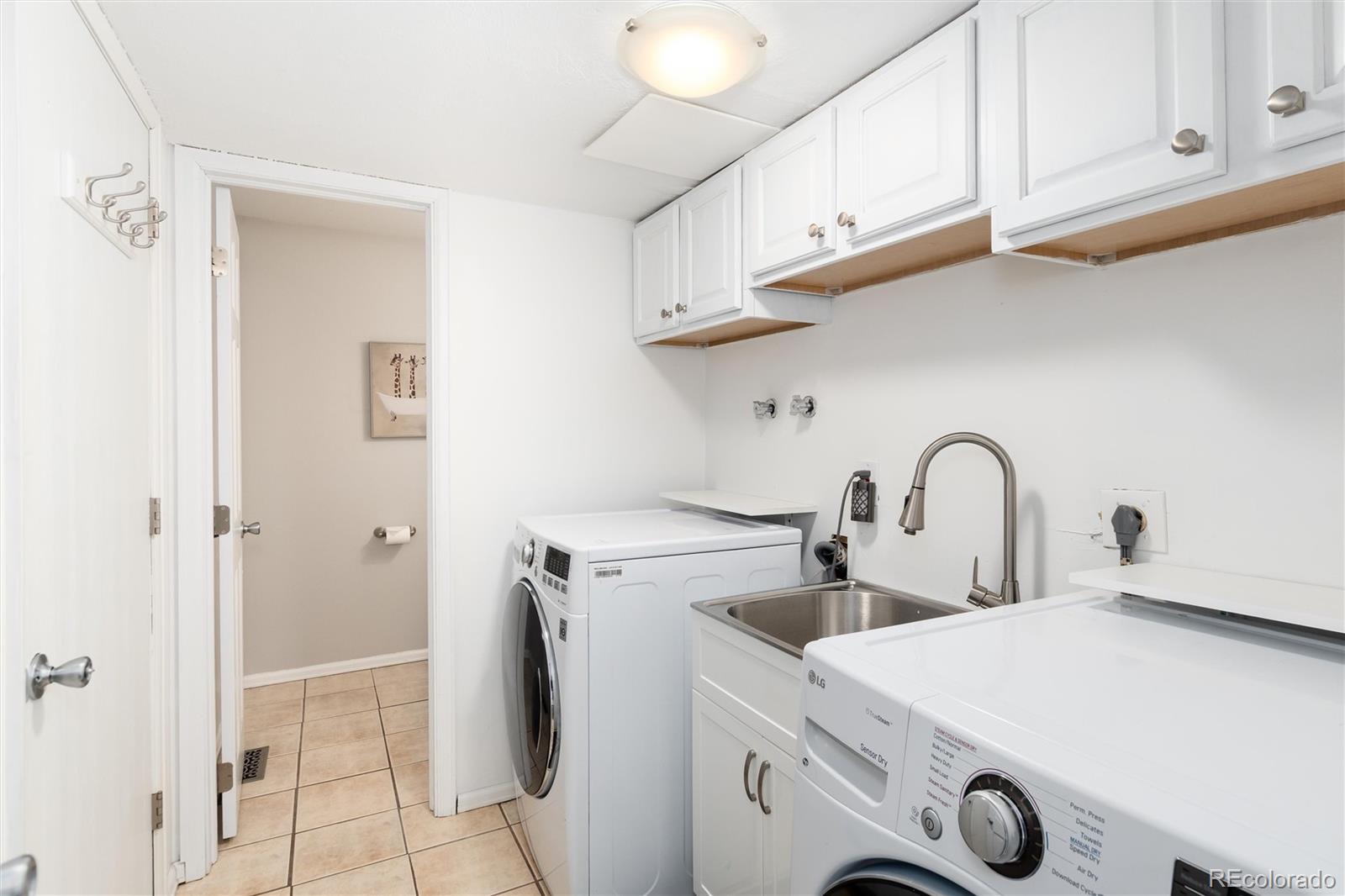 4935 South Routt Street Littleton, CO 80127 - Photo 19 of 45 a view of kitchen with washer and dryer
