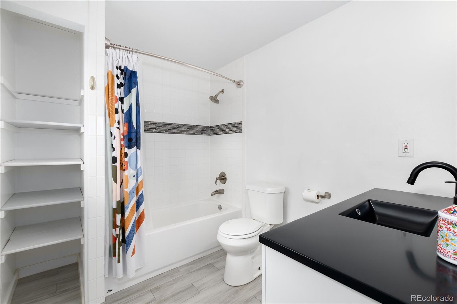 4935 South Routt Street Littleton, CO 80127 - Photo 24 of 45 a bathroom with a sink and a toilet