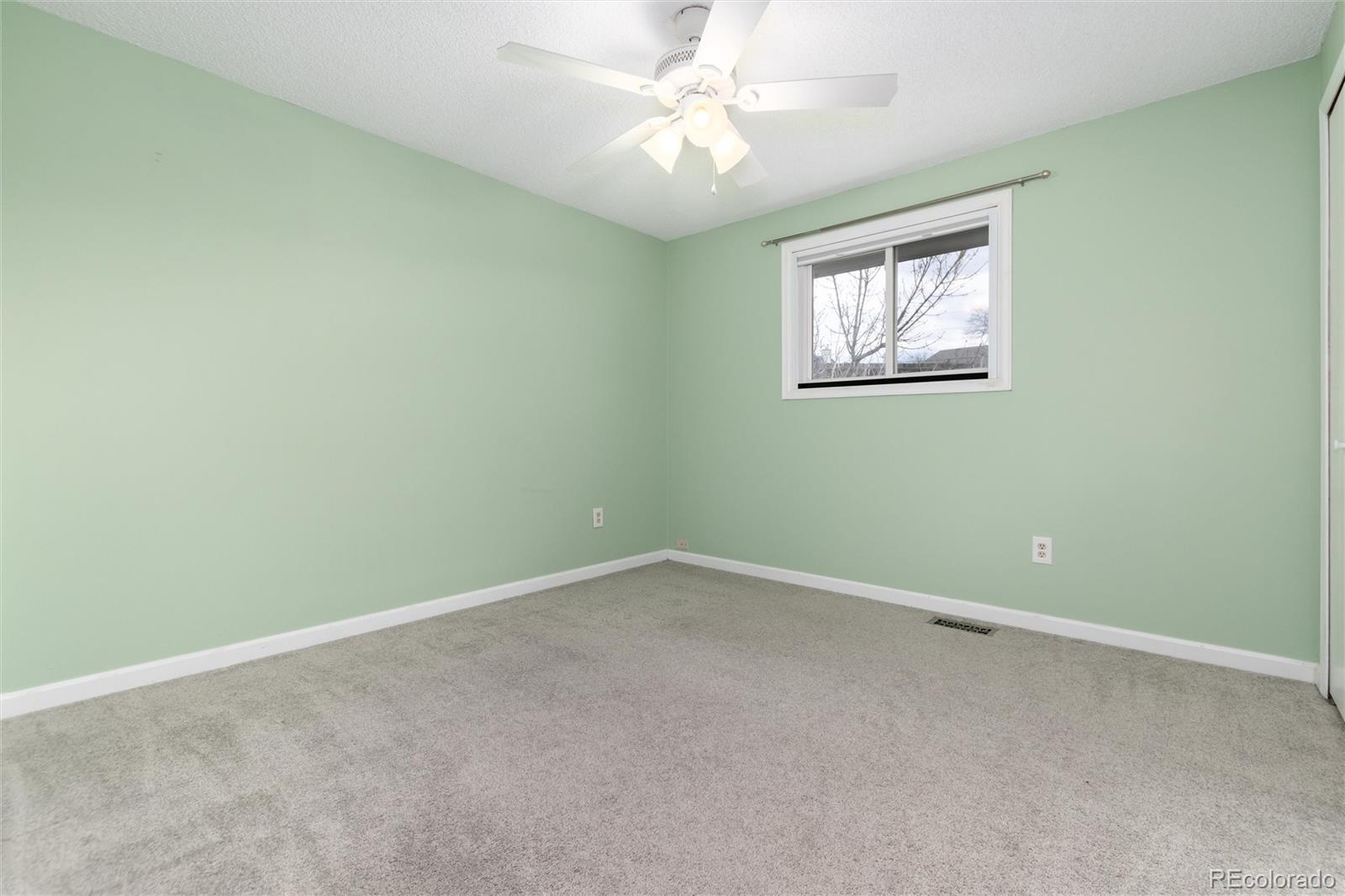 4935 South Routt Street Littleton, CO 80127 - Photo 25 of 45 an empty room with a window and a fan
