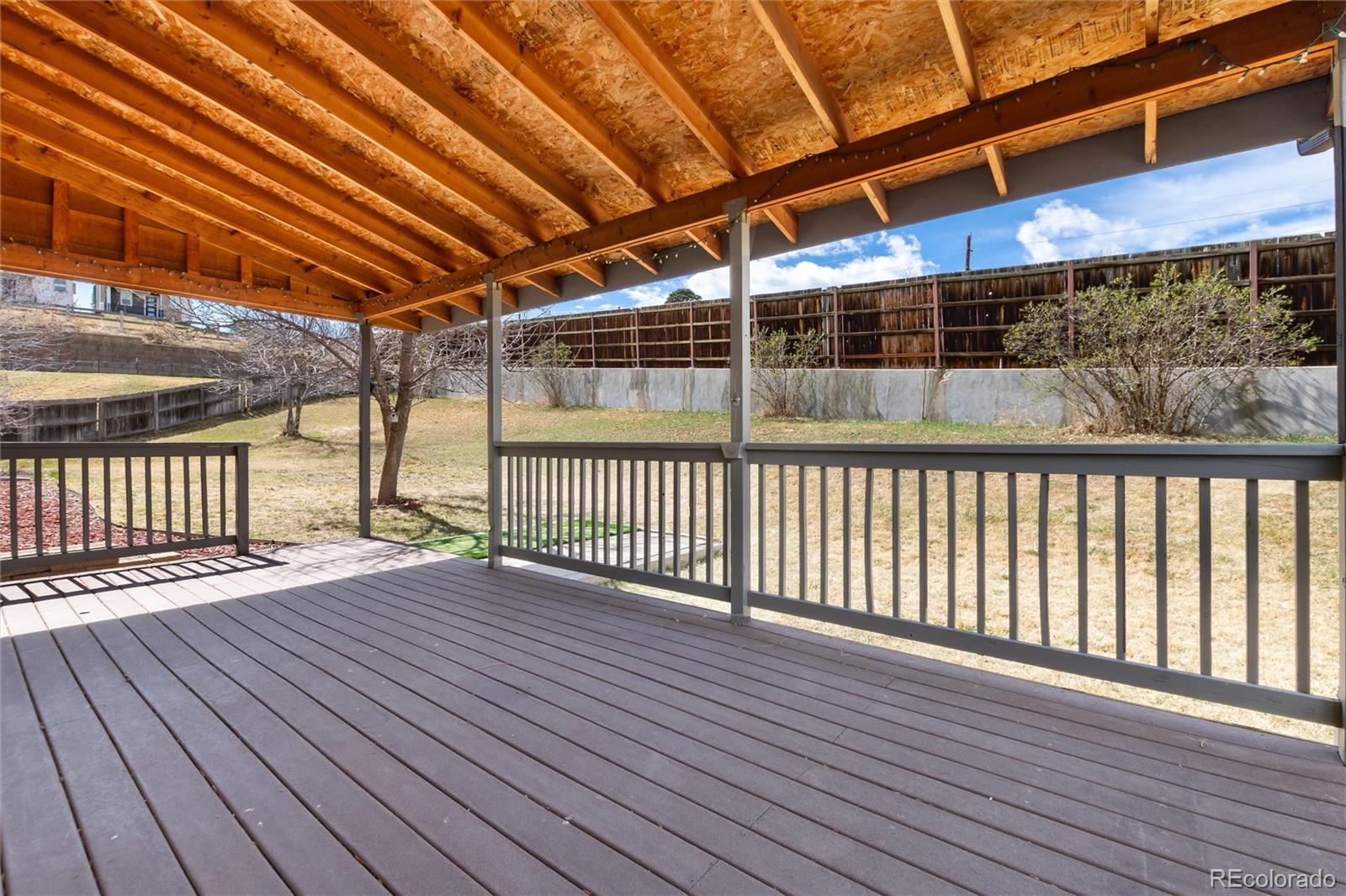 4935 South Routt Street Littleton, CO 80127 - Photo 32 of 45 a view of porch with wooden floor