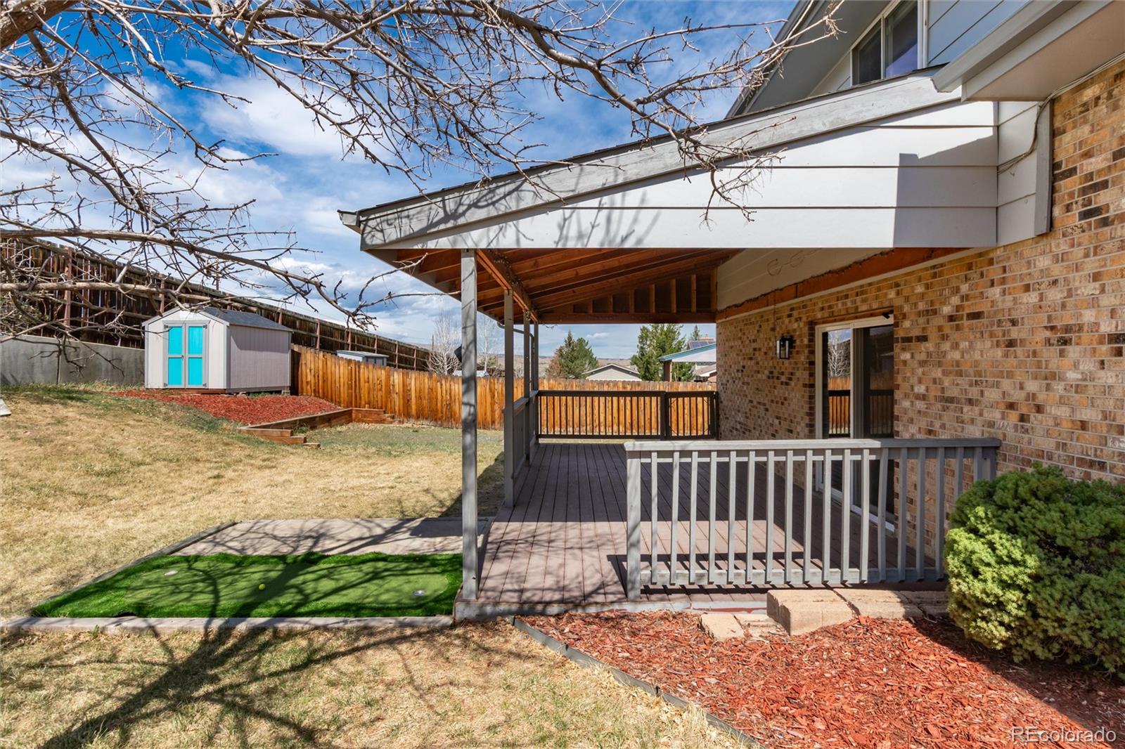 4935 South Routt Street Littleton, CO 80127 - Photo 33 of 45 a view of a backyard with a deck