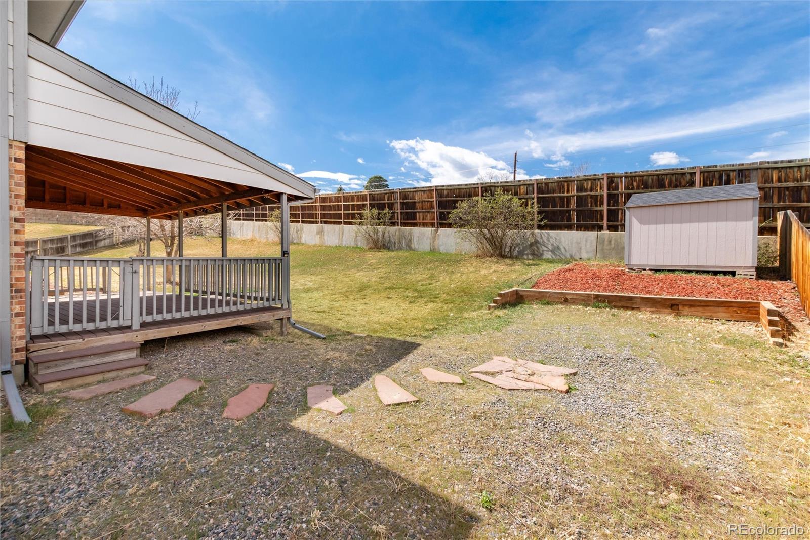 4935 South Routt Street Littleton, CO 80127 - Photo 34 of 45 a view of a backyard with swimming pool