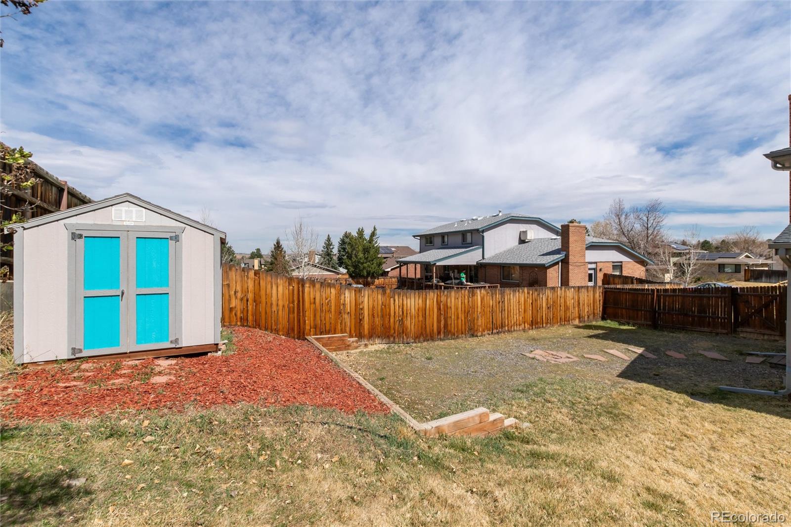 4935 South Routt Street Littleton, CO 80127 - Photo 37 of 45 a view of a house with a yard