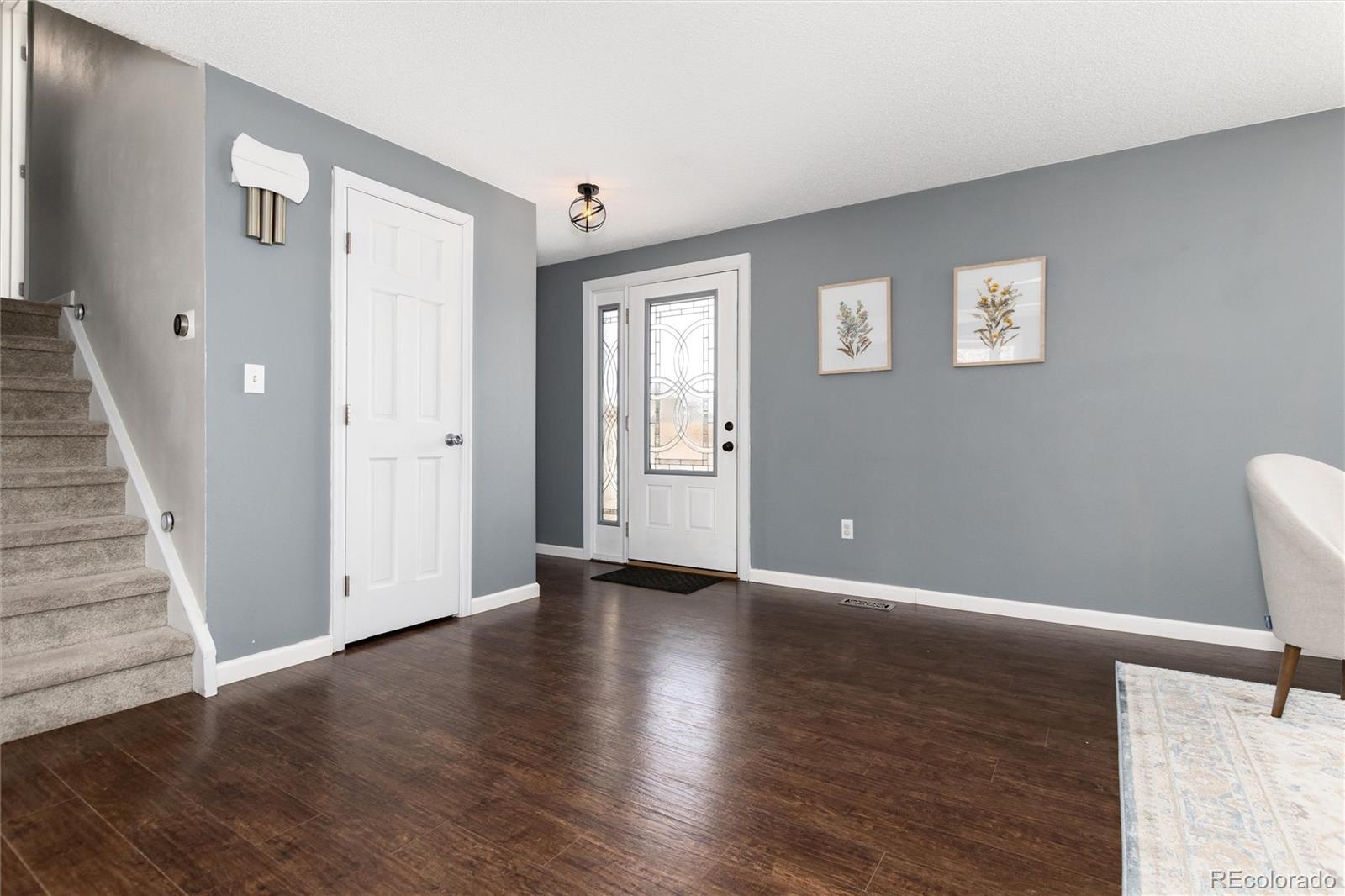 4935 South Routt Street Littleton, CO 80127 - Photo 5 of 45 a view of an empty room with wooden floor and a window