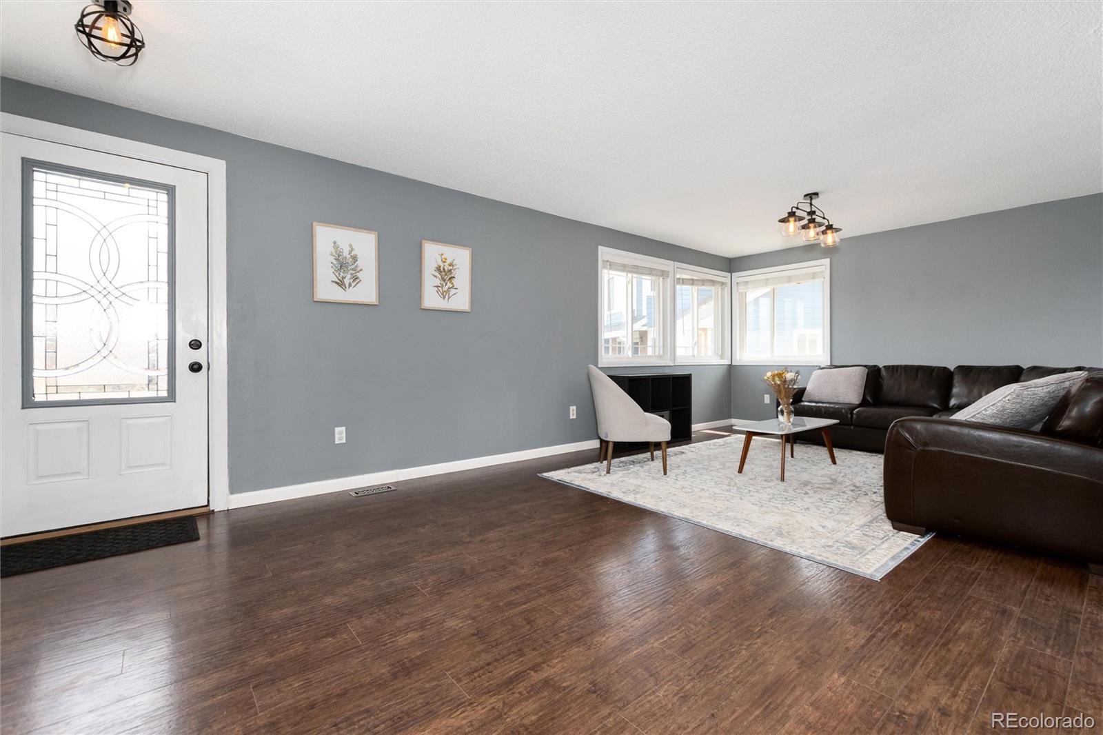 4935 South Routt Street Littleton, CO 80127 - Photo 7 of 45 a living room with furniture and a window