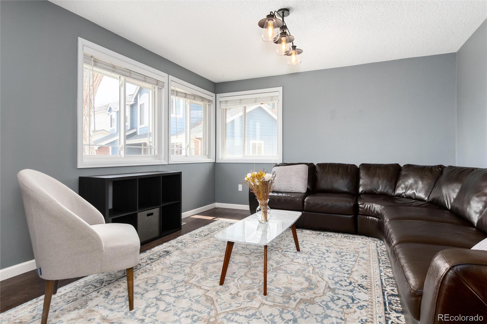 4935 South Routt Street Littleton, CO 80127 - Photo 8 of 45 a living room with furniture lamp and window
