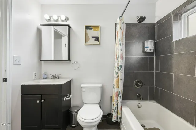 a white toilet sitting next to a bathroom sink
