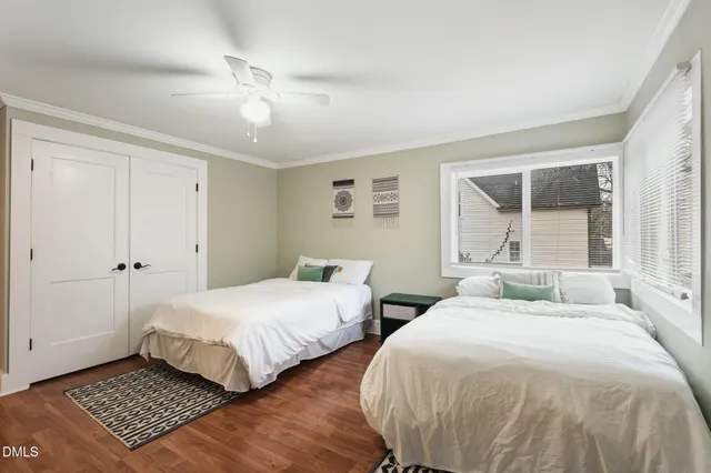 a bedroom with two beds and a window