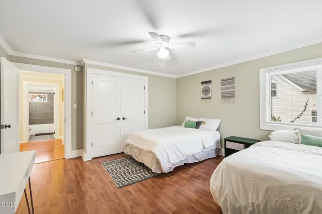 a bedroom with two beds and a chandelier