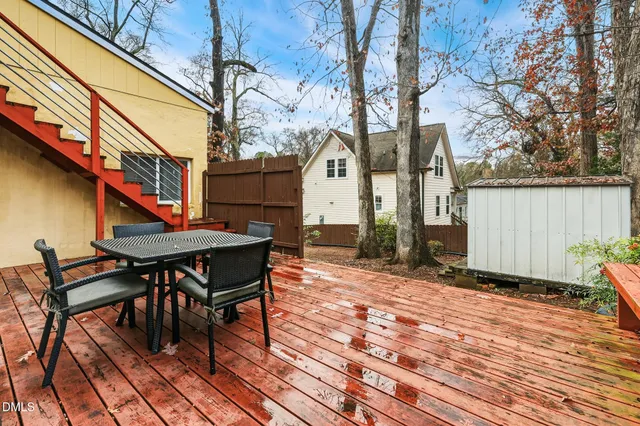 a backyard of a house with barbeque oven table and chairs