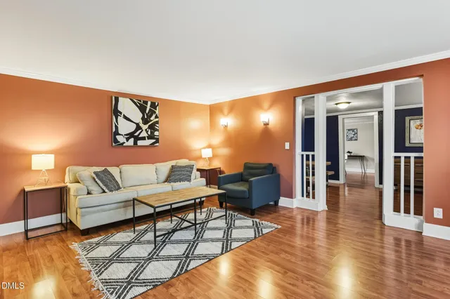a living room with furniture and wooden floor
