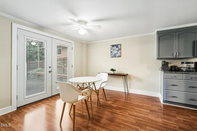 a view of a dining room with furniture wooden floor and chandelier