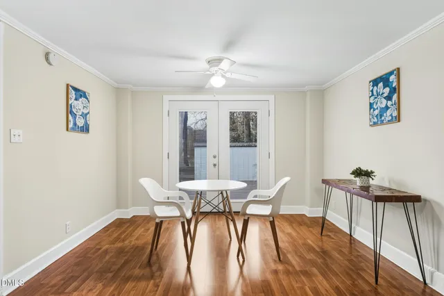 a view of a dining room with furniture wooden floor and a chandelier