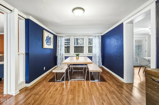a workspace with wooden floor and furniture