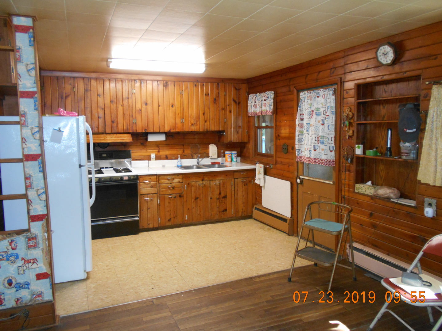 208 North 1st Street Ridge Farm, IL 61870 - Photo 21 of 23 a kitchen with stainless steel appliances granite countertop a refrigerator a stove and a dining table with wooden floor