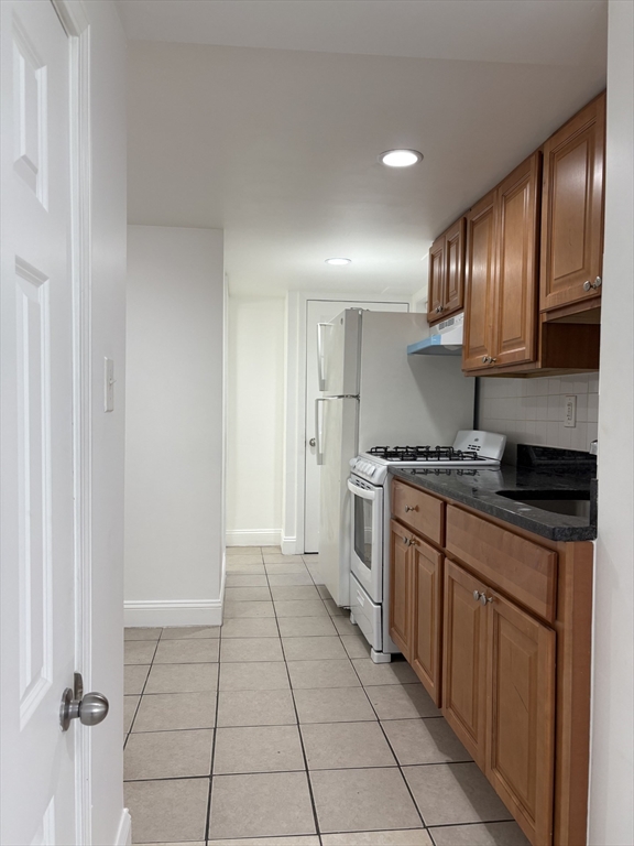 104 Beacon Street, Unit 1A Chelsea, MA 02150 - Photo 3 of 9 a kitchen with a sink cabinets and appliances