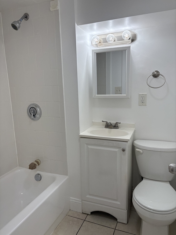 104 Beacon Street, Unit 1A Chelsea, MA 02150 - Photo 4 of 9 a bathroom with a sink a toilet and shower