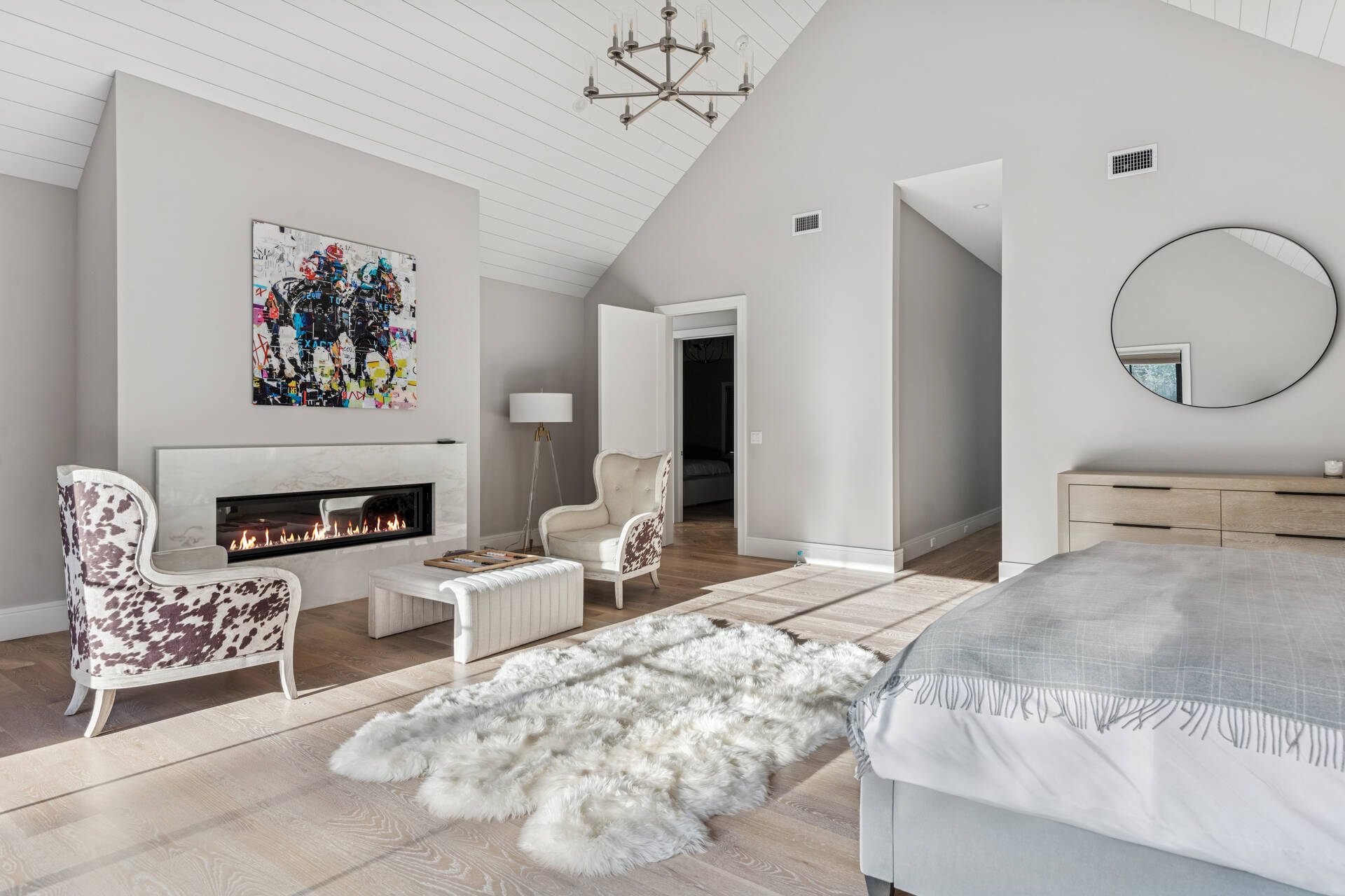 780 Sagg Road Sagaponack, NY 11962 - Photo 22 of 47 a bedroom with a bed a couch and a chandelier