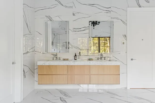 a bathroom with a bathtub shower sink vanity and toilet