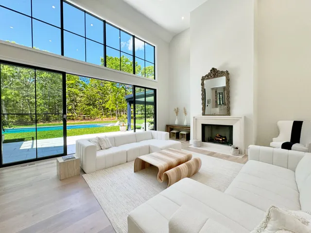 a view of living room and kitchen with furniture wooden floor and window