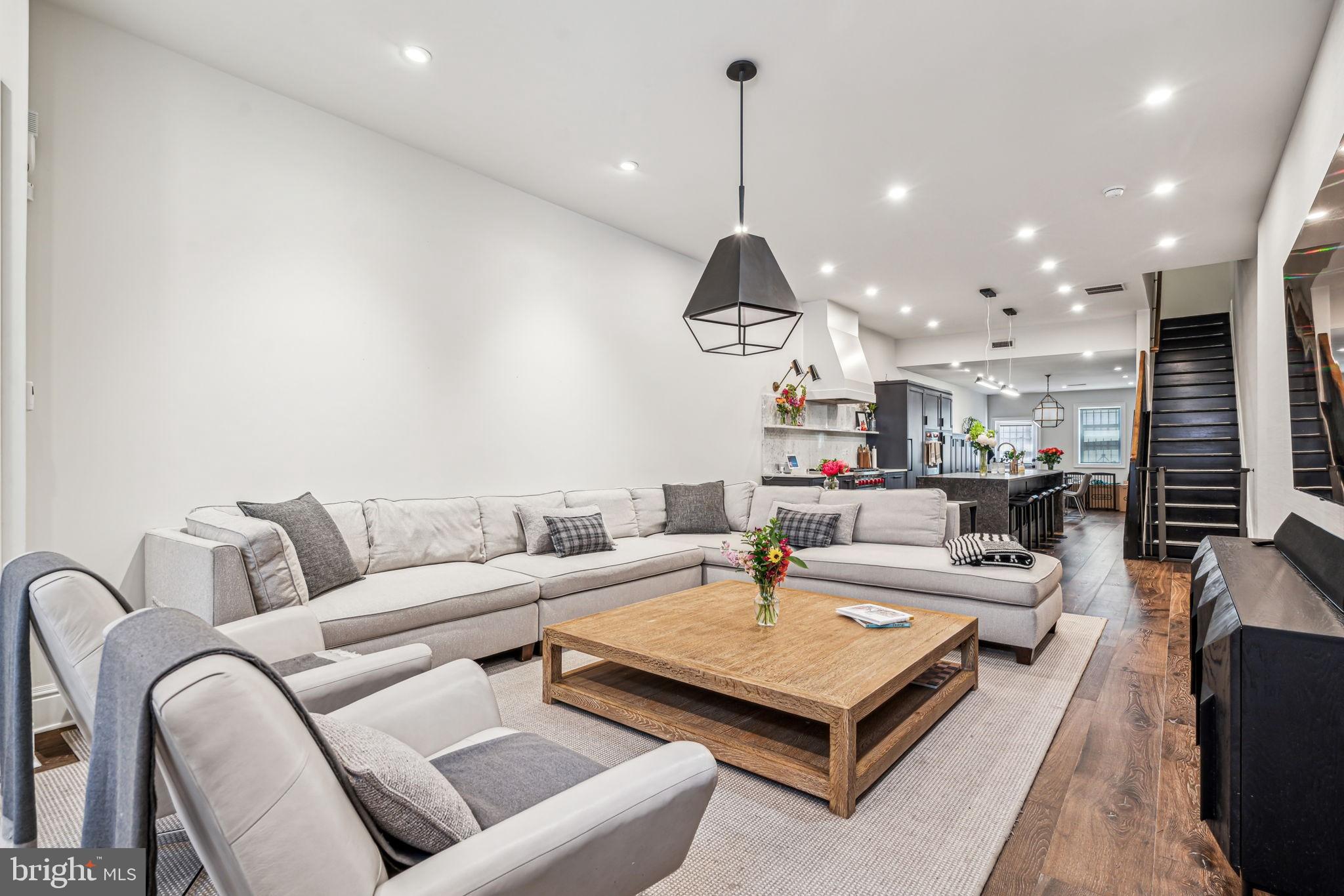 a living room with furniture and wooden floor