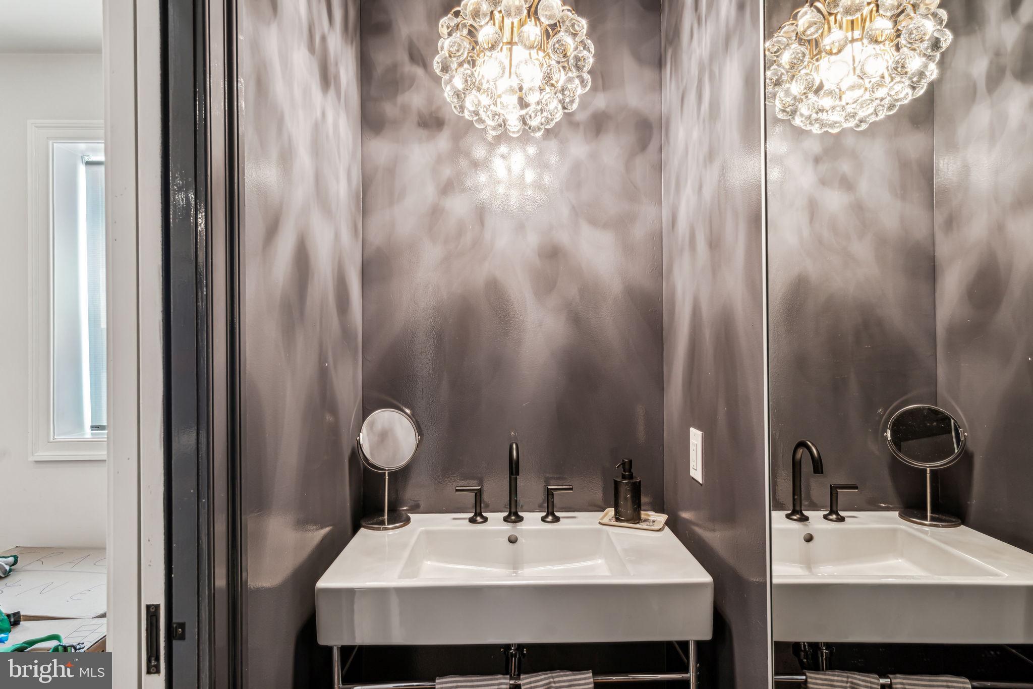 1710 Rittenhouse Square Philadelphia, PA 19103 - Photo 12 of 28 a bathroom with a sink and a mirror