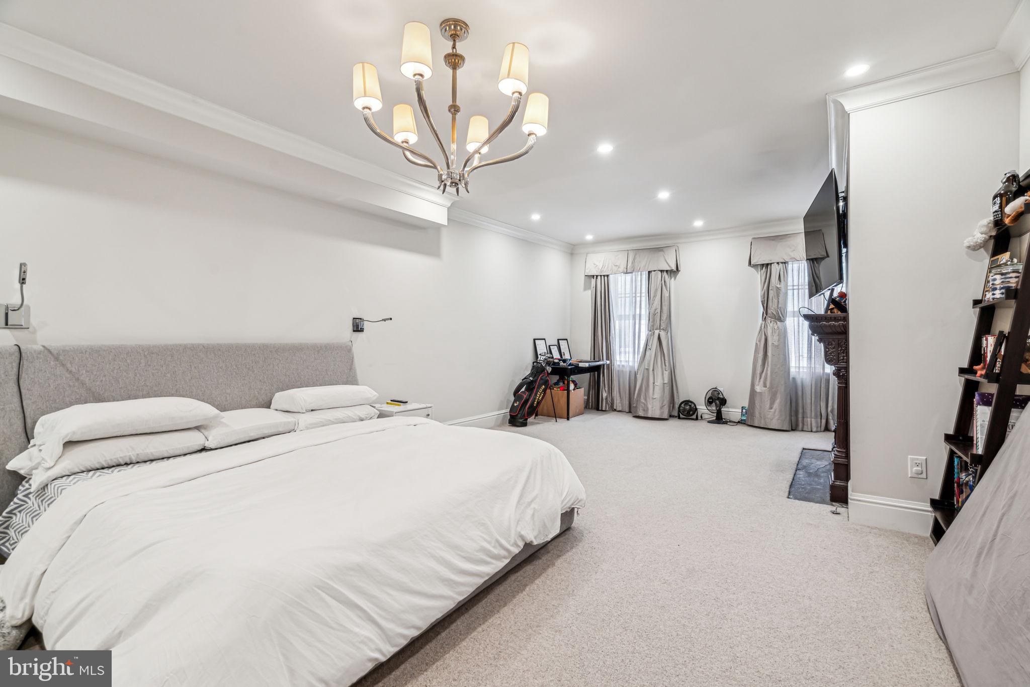 1710 Rittenhouse Square Philadelphia, PA 19103 - Photo 13 of 28 a spacious bedroom with a bed and a chandelier