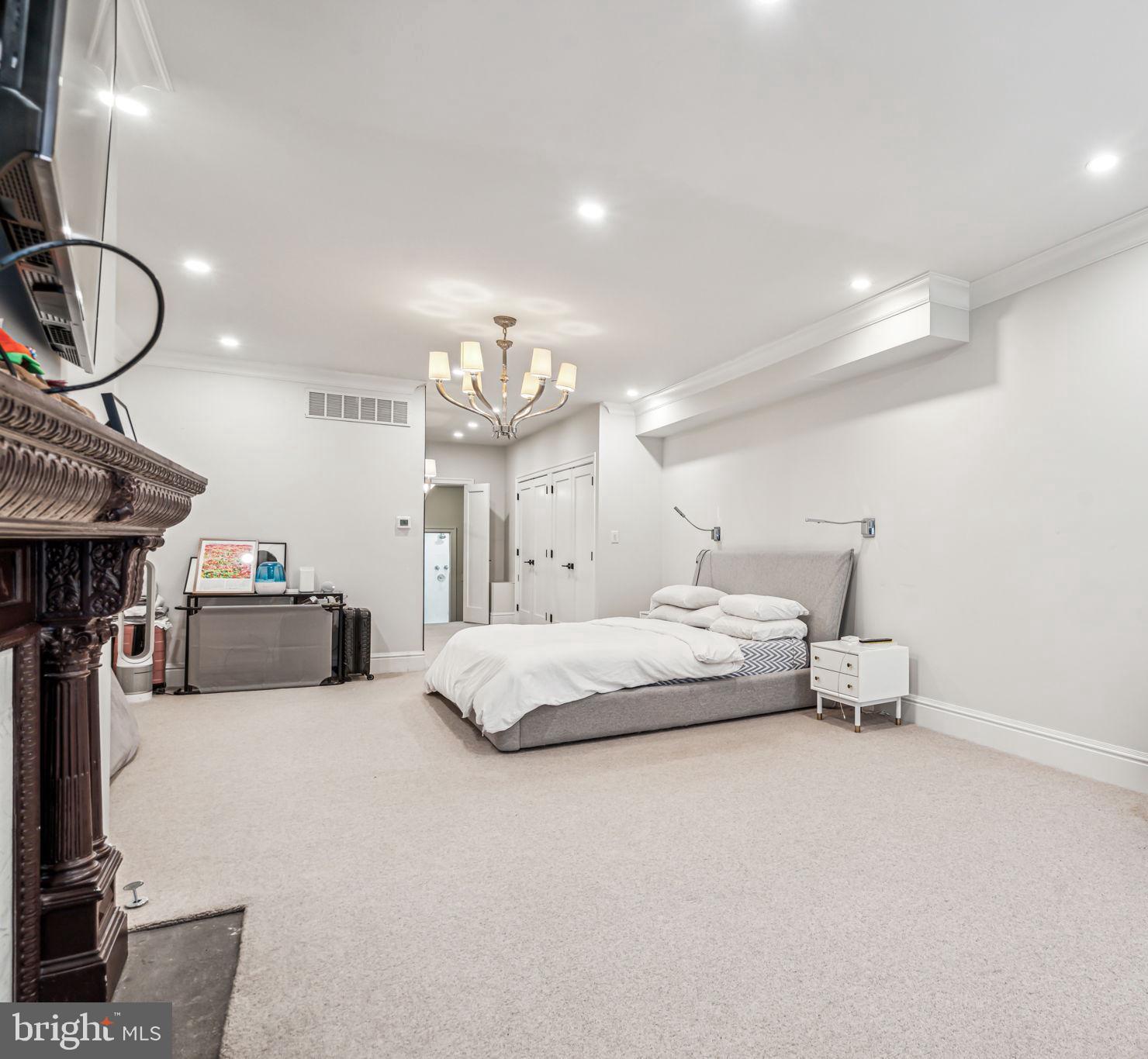 1710 Rittenhouse Square Philadelphia, PA 19103 - Photo 14 of 28 a spacious bedroom with a bed and a chandelier