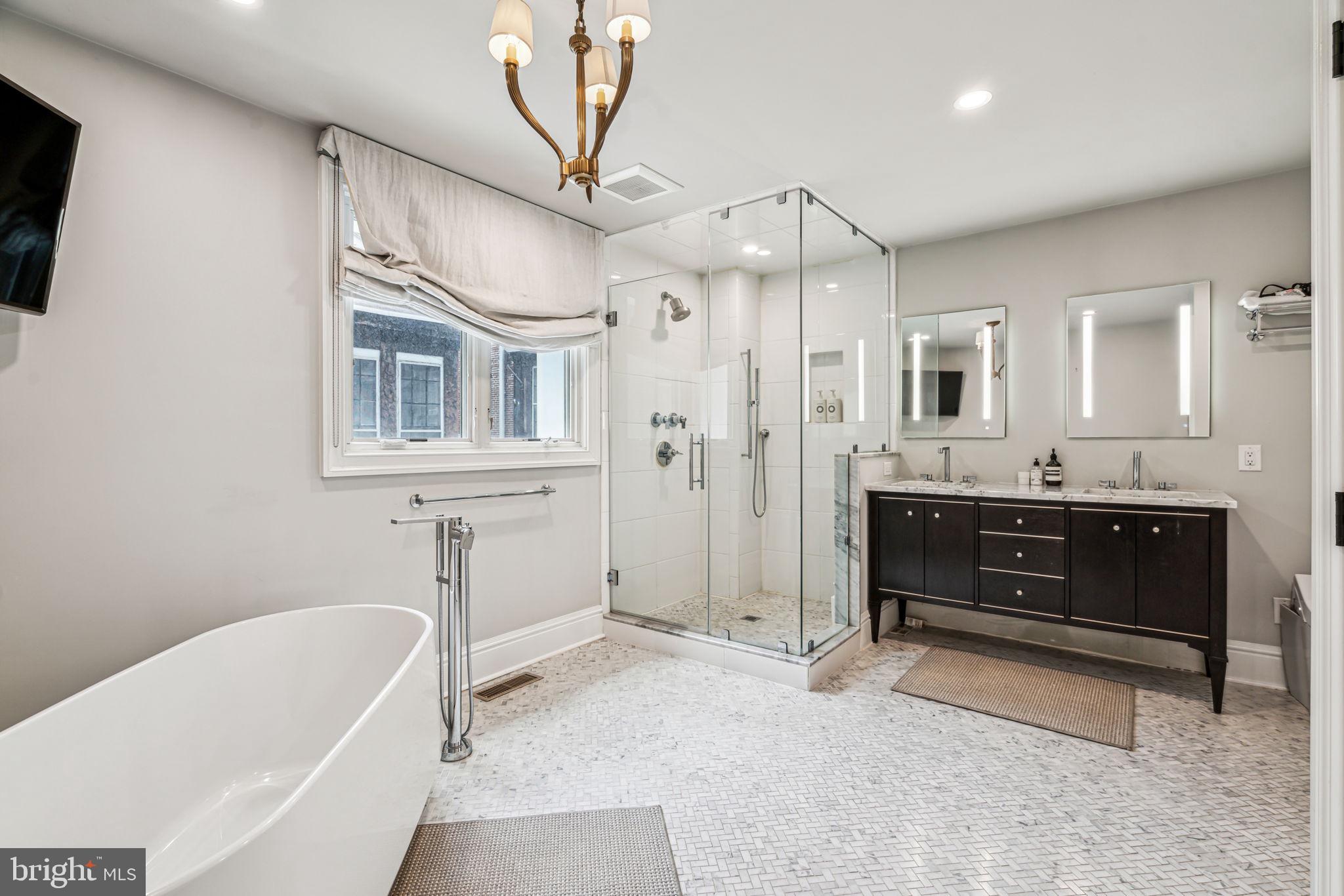 1710 Rittenhouse Square Philadelphia, PA 19103 - Photo 16 of 28 a spacious bathroom with a tub sink and mirror