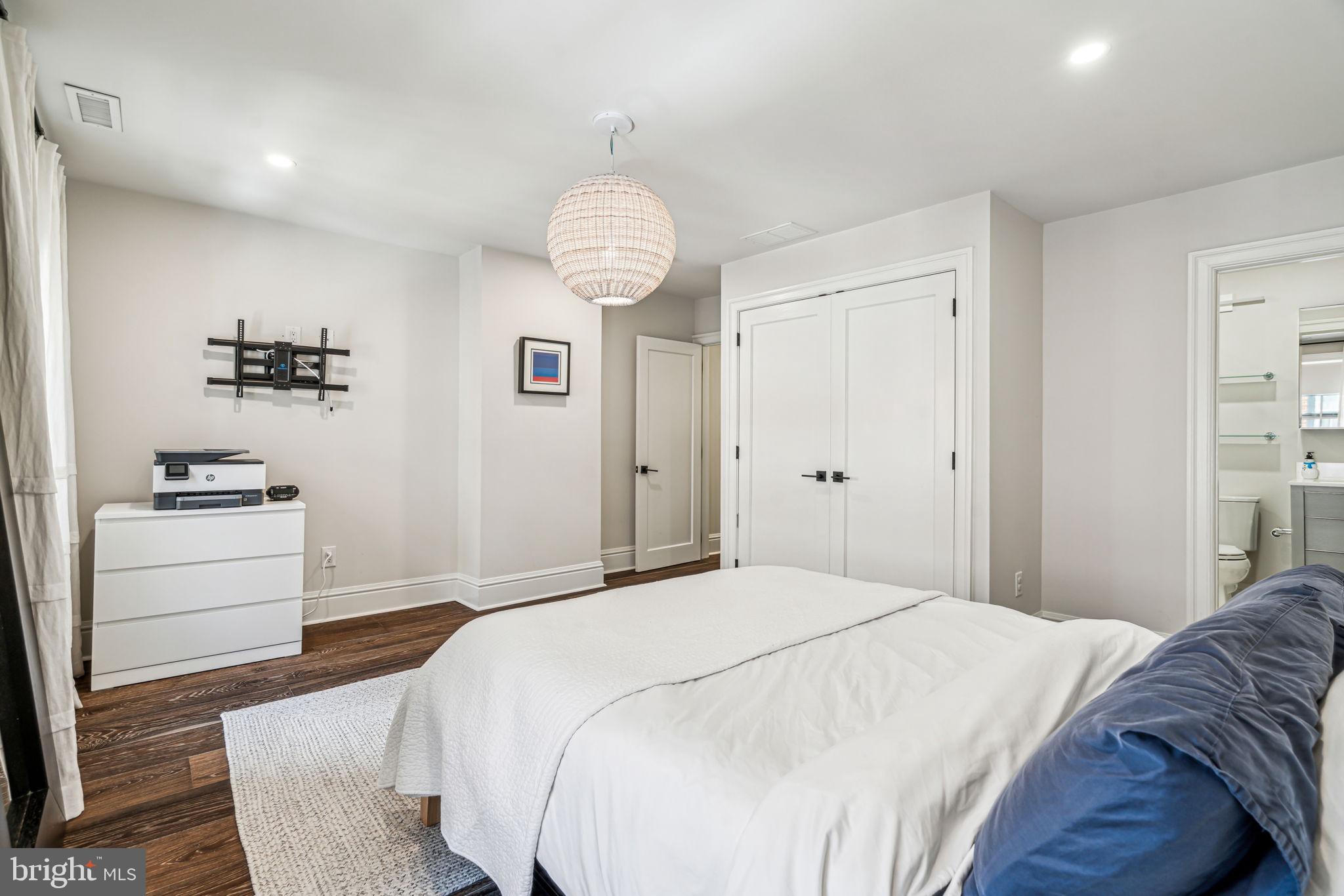 1710 Rittenhouse Square Philadelphia, PA 19103 - Photo 21 of 28 a spacious bedroom with a bed and a chandelier