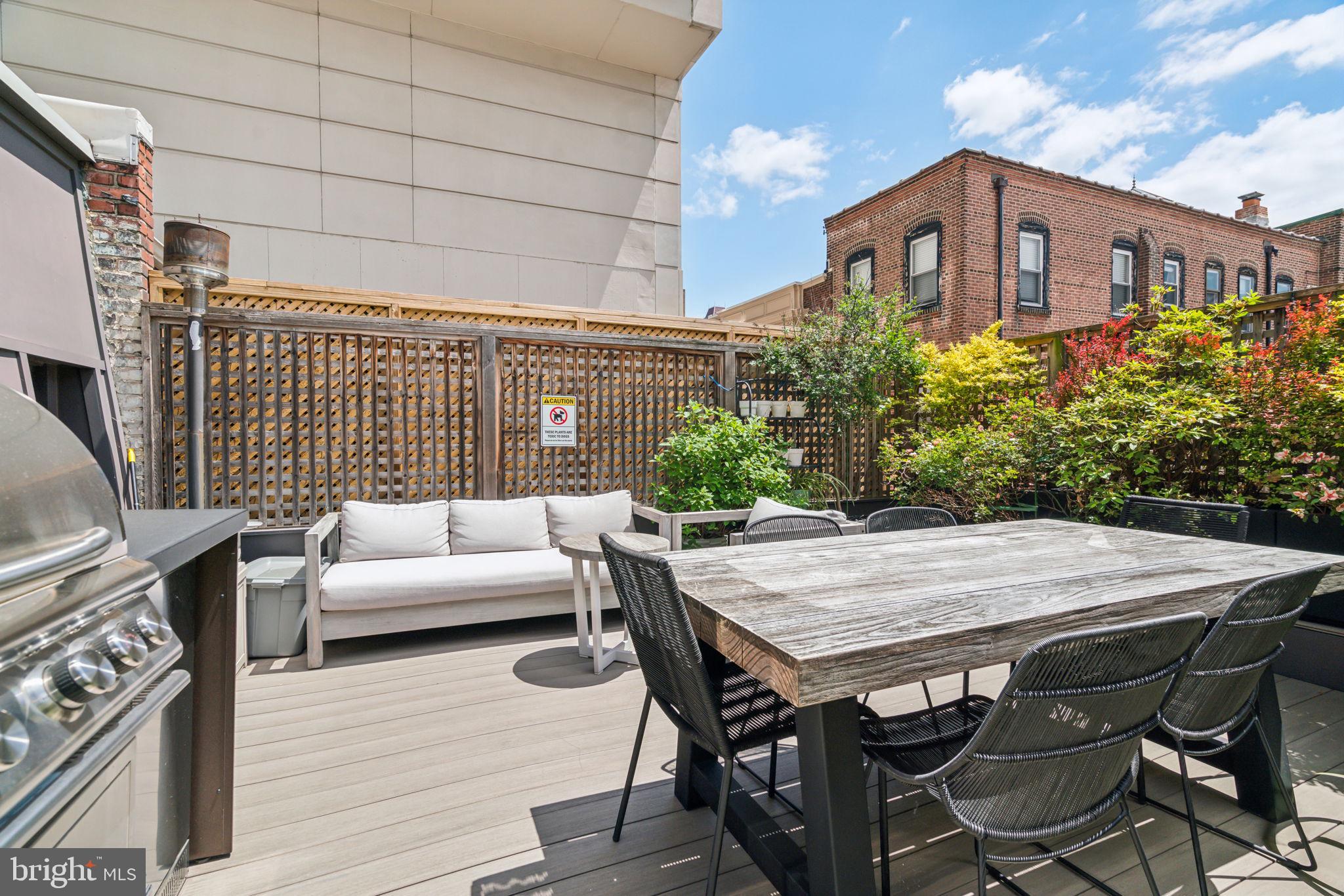 1710 Rittenhouse Square Philadelphia, PA 19103 - Photo 28 of 28 a view of a patio with table and chairs with wooden floor and fence